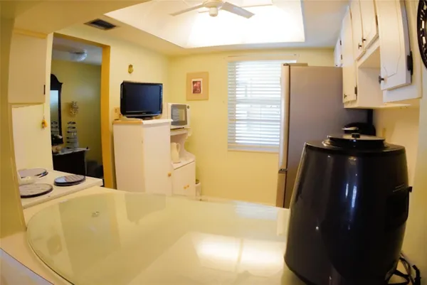 a kitchen with a stove and wooden floor