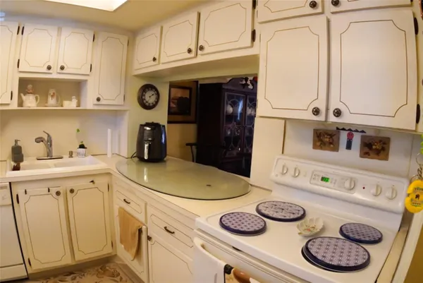 a kitchen with a refrigerator a stove a microwave and cabinets