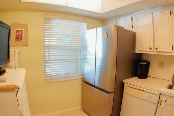 a living room with a flat screen tv and washer
