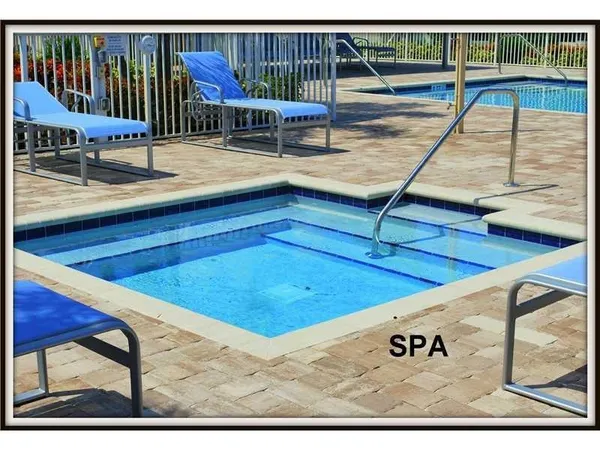 a swimming pool with outdoor seating and yard