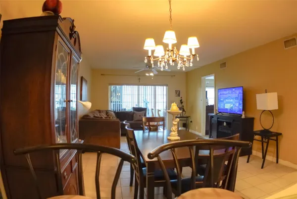 a view of a dining room with furniture and chandelier