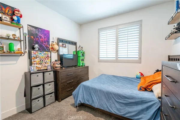 a bed room with a bed window and a chair