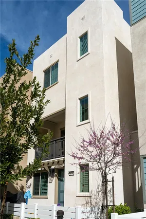 a front view of a house with a tree