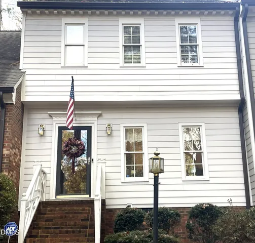 a view of a house with more windows and brick walls