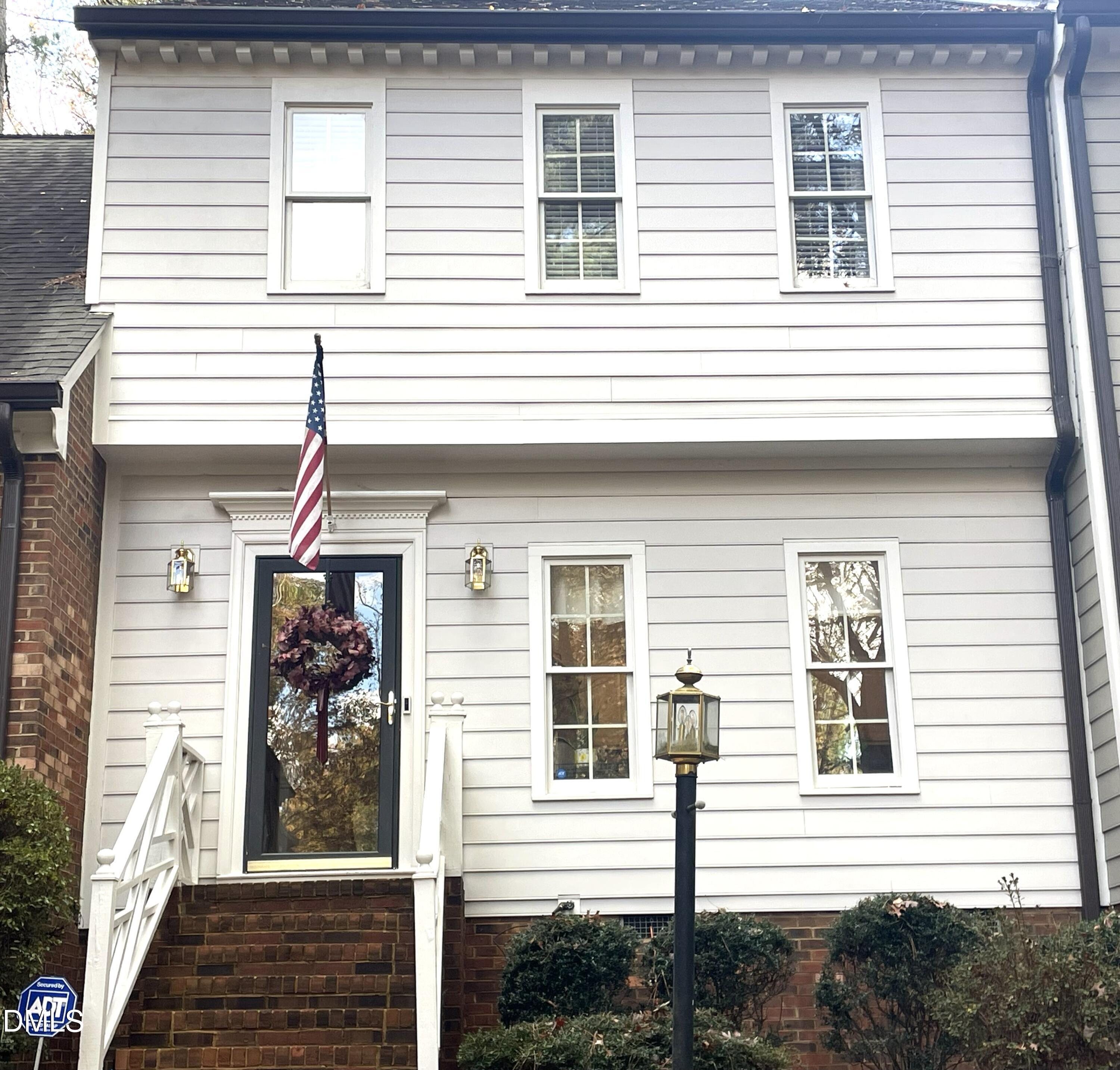 a view of a house with more windows and brick walls