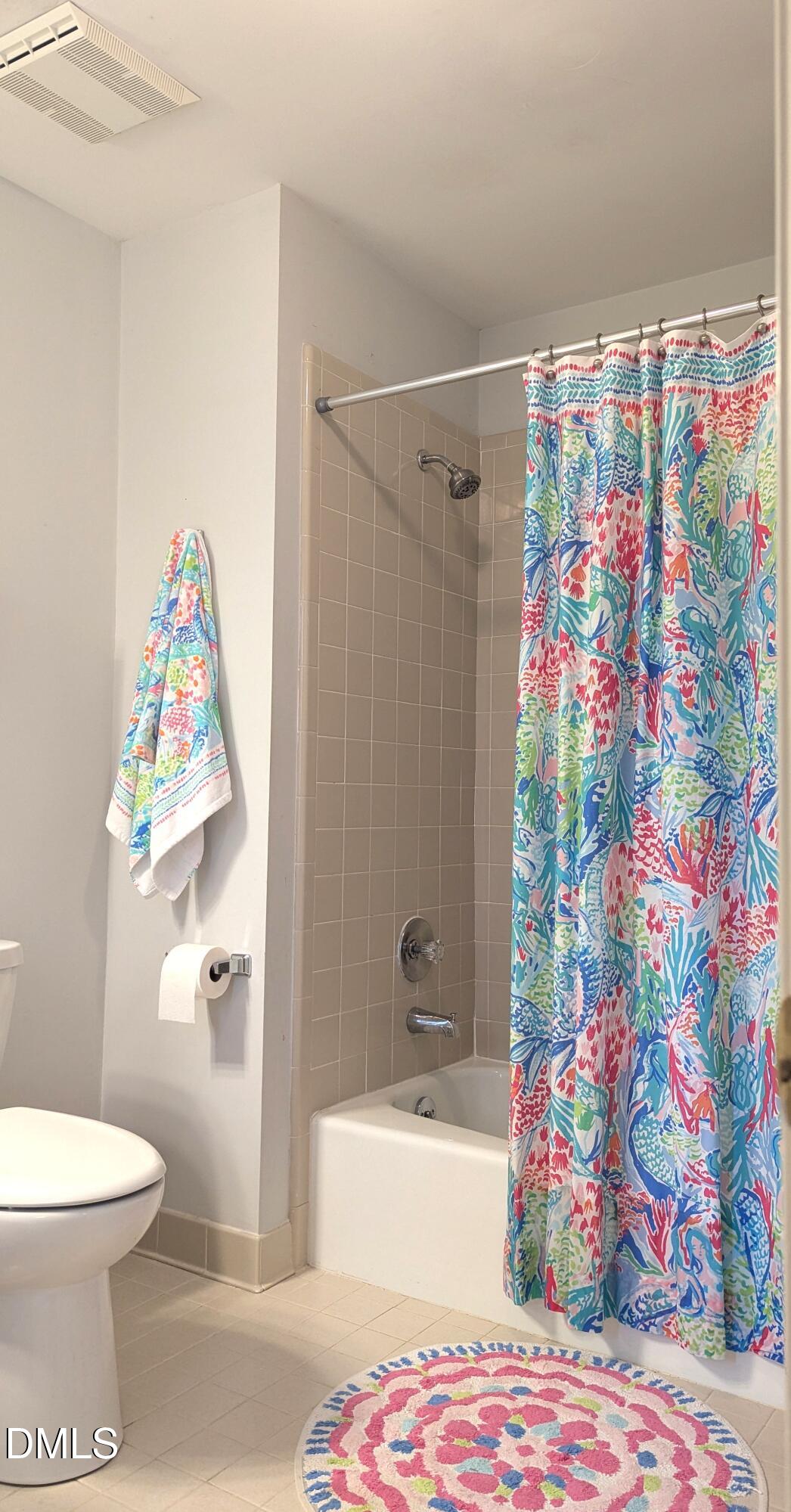 540 Weathergreen Drive Raleigh, NC 27615 - Photo 12 of 20 a bathroom with a toilet and a shower curtain