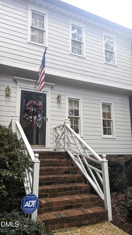a front view of house with a garden