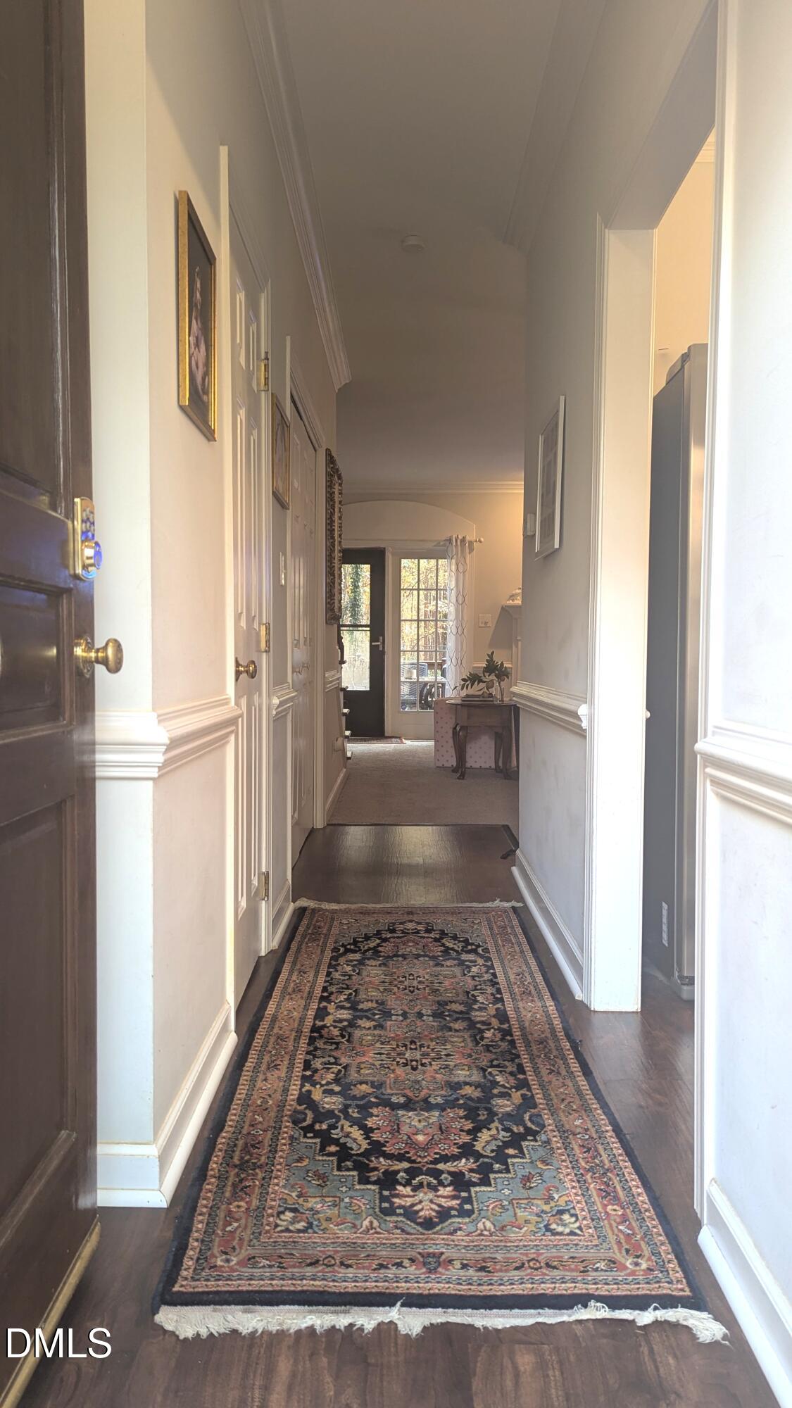 540 Weathergreen Drive Raleigh, NC 27615 - Photo 4 of 20 a view of a hallway with wooden floor and a refrigerator