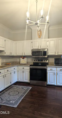 a kitchen with granite countertop wooden cabinets and stainless steel appliances