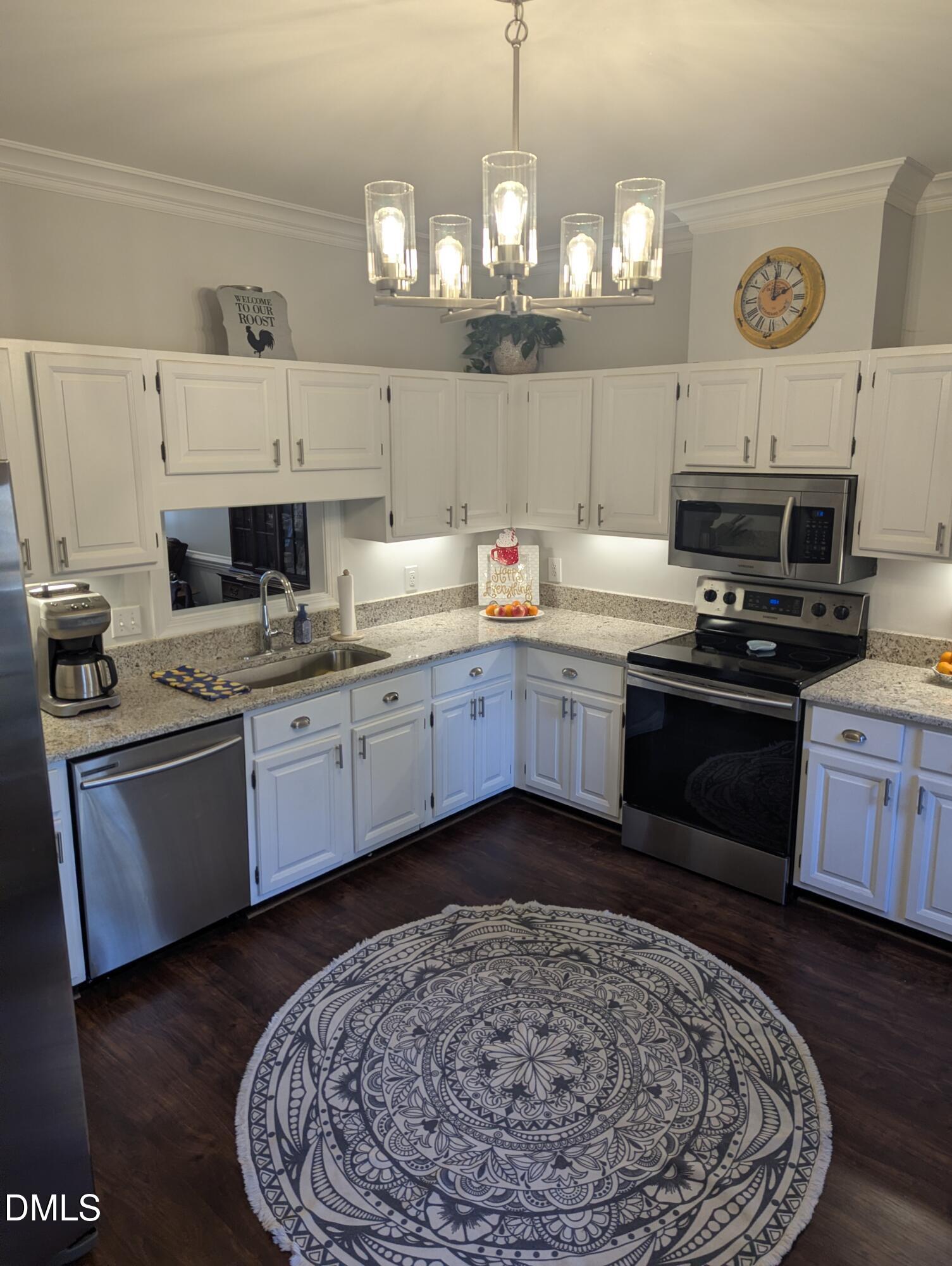540 Weathergreen Drive Raleigh, NC 27615 - Photo 5 of 20 a kitchen with a sink stove and microwave