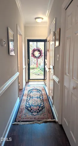 a room with large window and rug