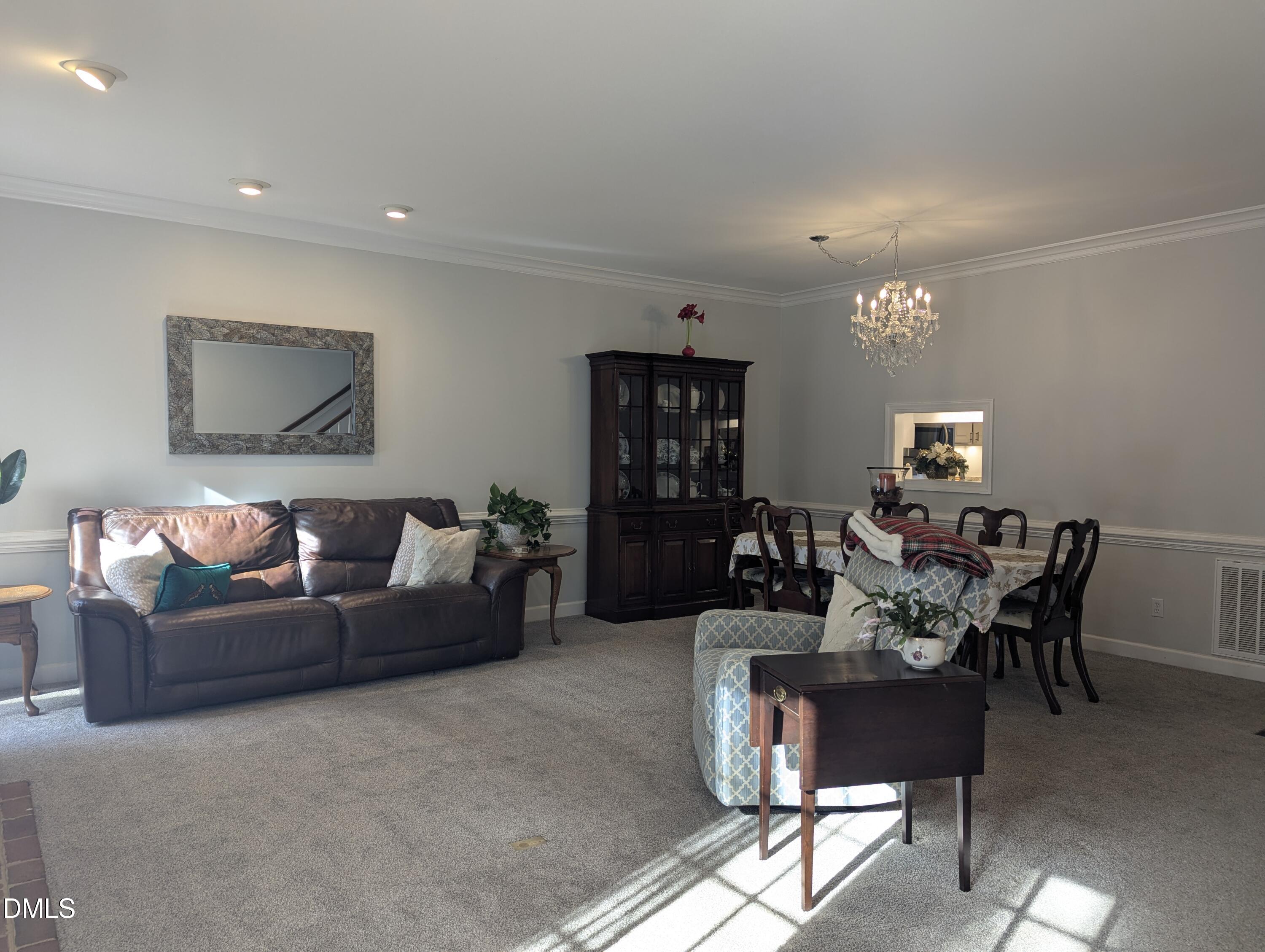 540 Weathergreen Drive Raleigh, NC 27615 - Photo 10 of 20 a living room with furniture and a flat screen tv