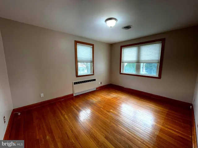 a view of an empty room and wooden floor