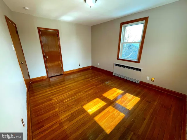 a bathroom with a granite countertop toilet sink and mirror