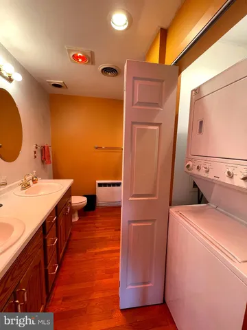 a view of a deck with wooden floor and fence with a barbeque