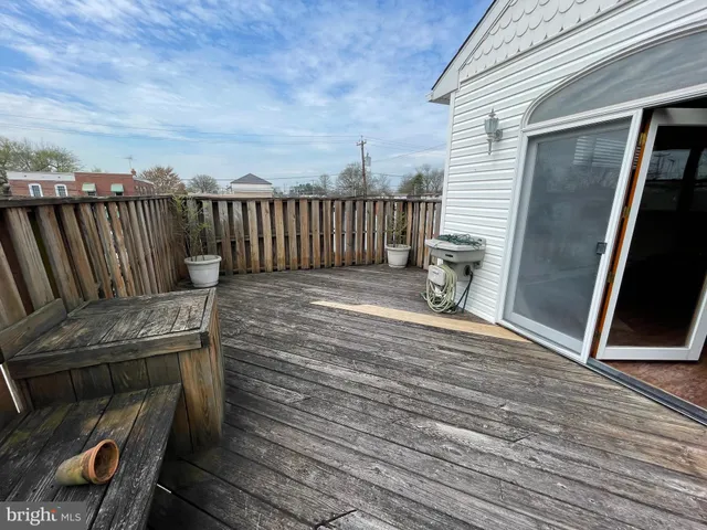 a view of a house with wooden deck