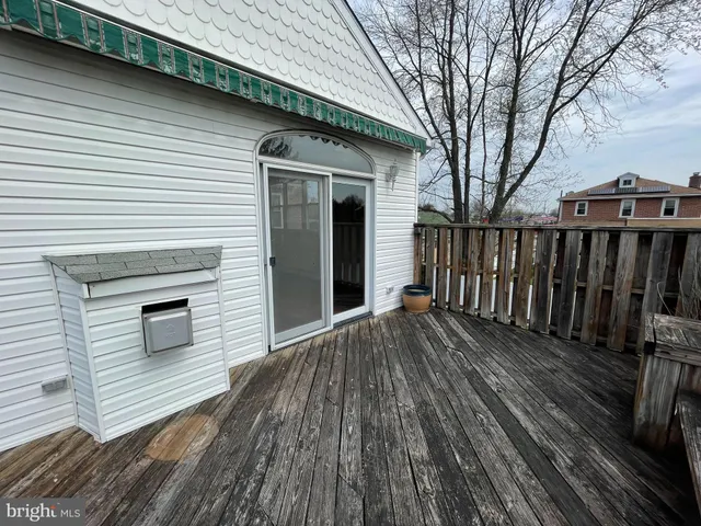 a view of balcony with wooden floor and fence
