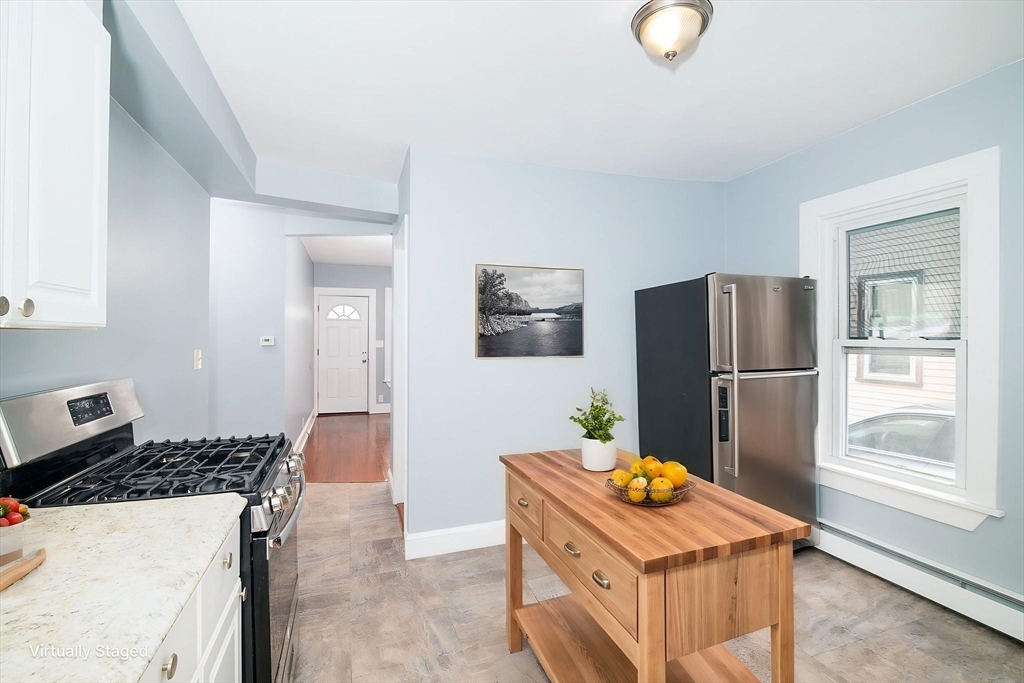 79 Gilbert Street Quincy, MA 02169 - Photo 11 of 38 a kitchen with stainless steel appliances granite countertop a refrigerator and a stove