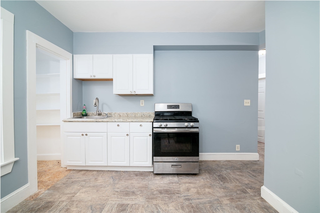 79 Gilbert Street Quincy, MA 02169 - Photo 12 of 38 a kitchen with stainless steel appliances granite countertop a sink and a stove