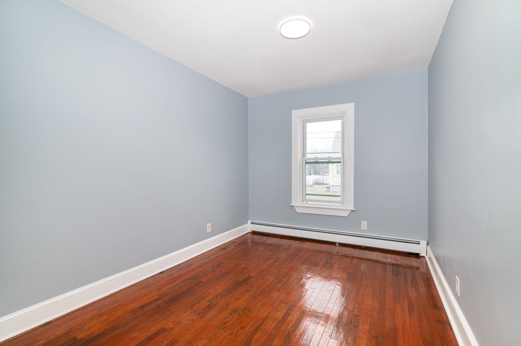 79 Gilbert Street Quincy, MA 02169 - Photo 13 of 38 an empty room with wooden floor and windows