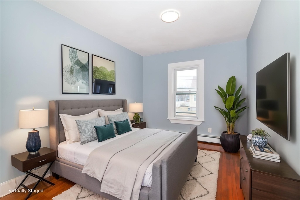 79 Gilbert Street Quincy, MA 02169 - Photo 14 of 38 a bedroom with a bed and a flat screen tv