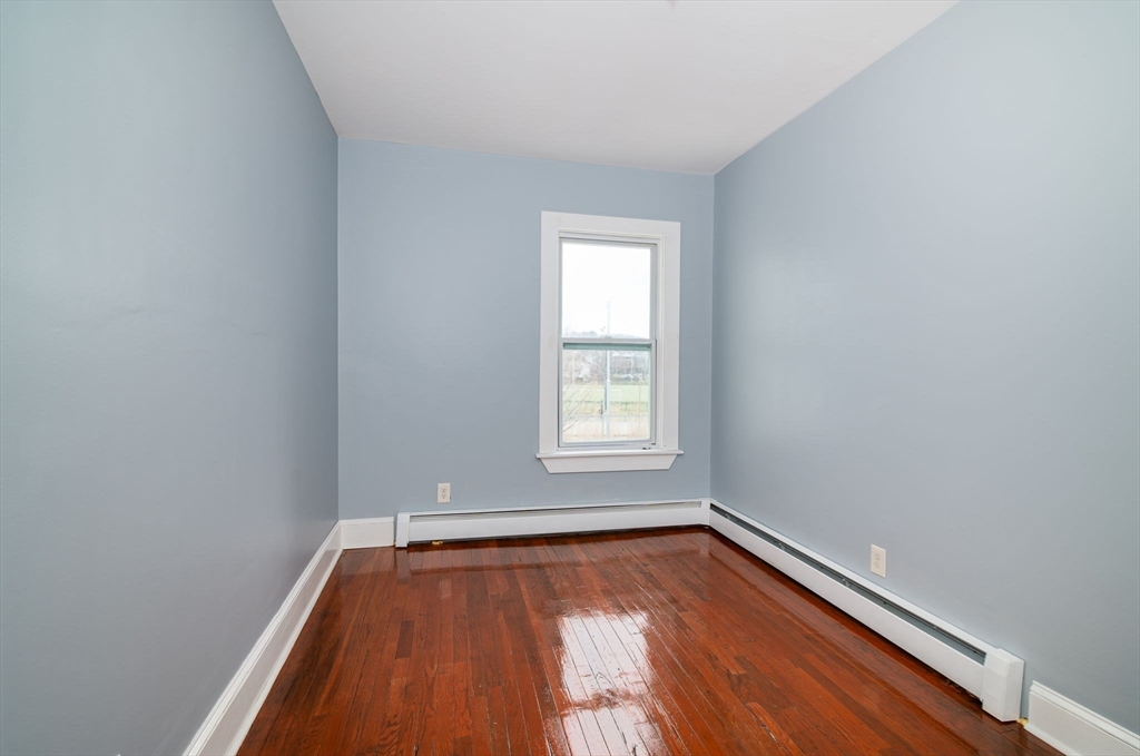 79 Gilbert Street Quincy, MA 02169 - Photo 17 of 38 a view of room with window and wooden floor