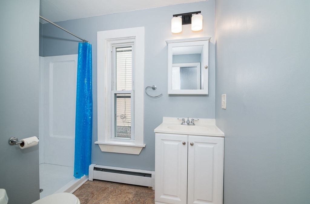 79 Gilbert Street Quincy, MA 02169 - Photo 19 of 38 a bathroom with a sink a mirror and a toilet