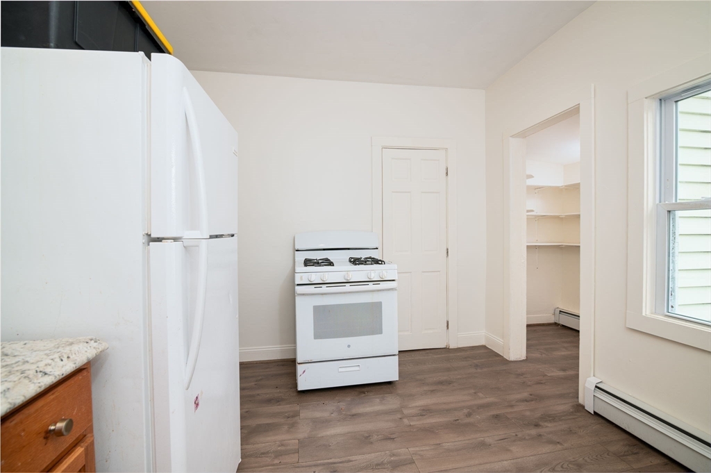 79 Gilbert Street Quincy, MA 02169 - Photo 20 of 38 a view of a kitchen with a stove cabinets and a wooden floor