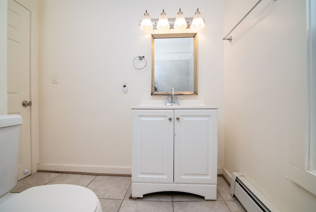 79 Gilbert Street Quincy, MA 02169 - Photo 23 of 38 a bathroom with a sink a toilet and mirror