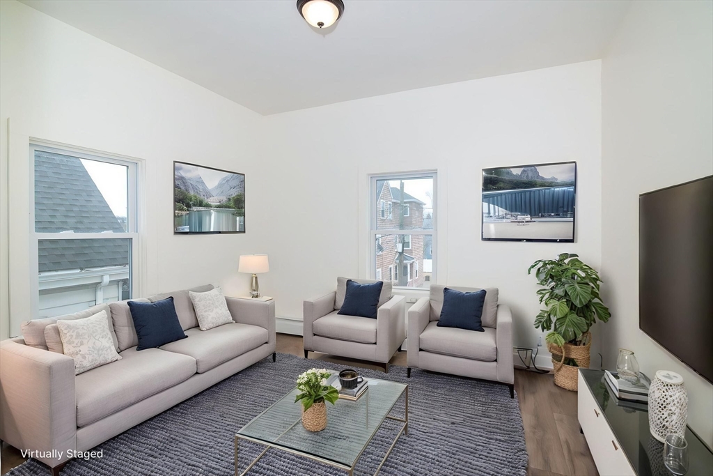 79 Gilbert Street Quincy, MA 02169 - Photo 25 of 38 a living room with furniture and a potted plant