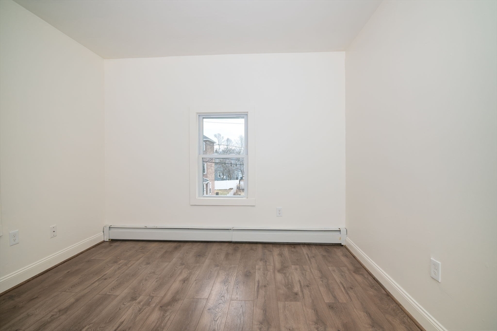 79 Gilbert Street Quincy, MA 02169 - Photo 26 of 38 an empty room with a wooden floor and window