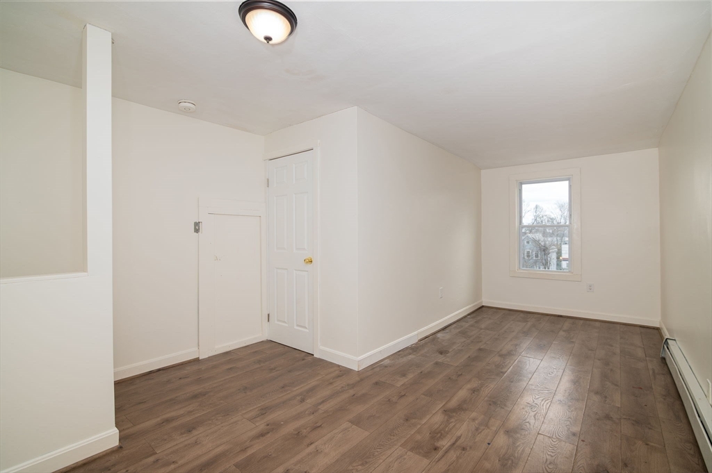 79 Gilbert Street Quincy, MA 02169 - Photo 29 of 38 an empty room with wooden floor and windows