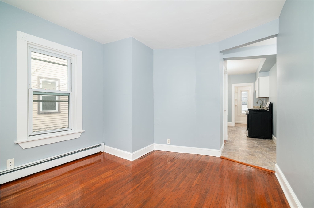 79 Gilbert Street Quincy, MA 02169 - Photo 5 of 38 wooden floor in an empty room with a window
