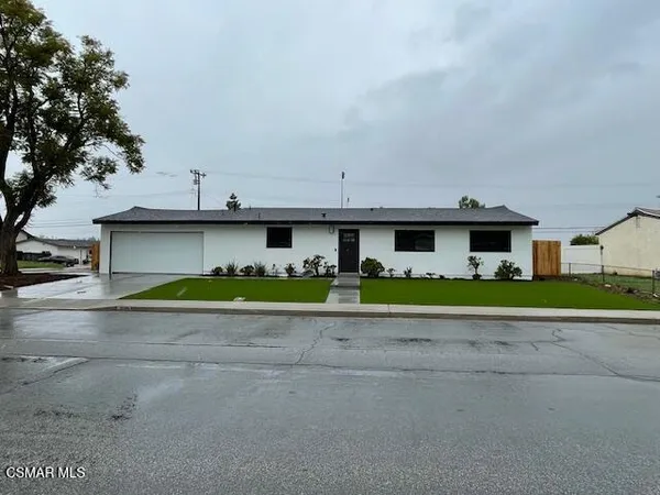 a view of front of house with a yard