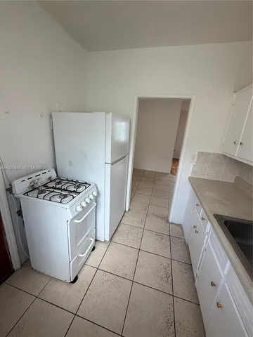 a kitchen with granite countertop a stove and a sink