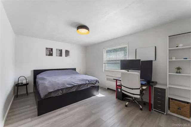 a bedroom with a bed and a desk