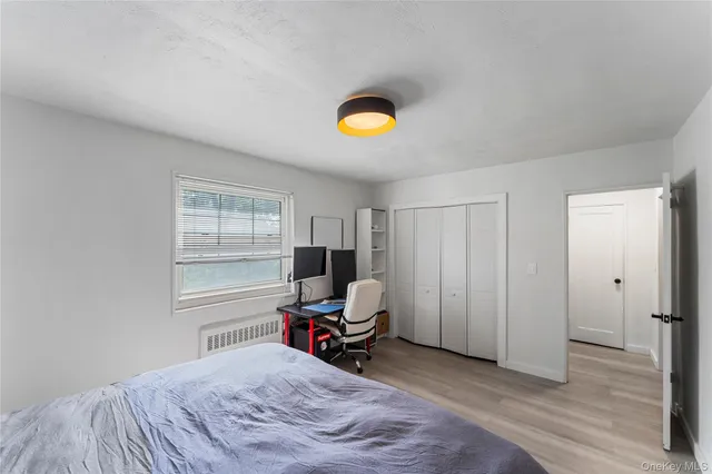 a bedroom with a bed and window