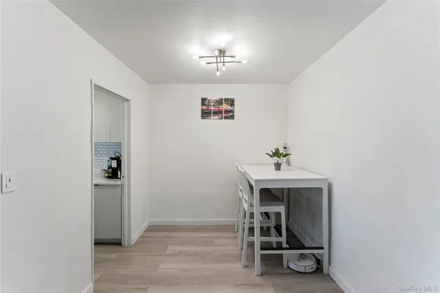 a view of a hallway with workspace and a window