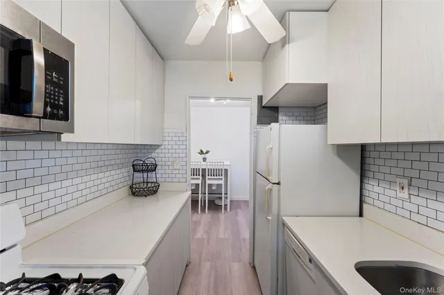 a kitchen with refrigerator and cabinets