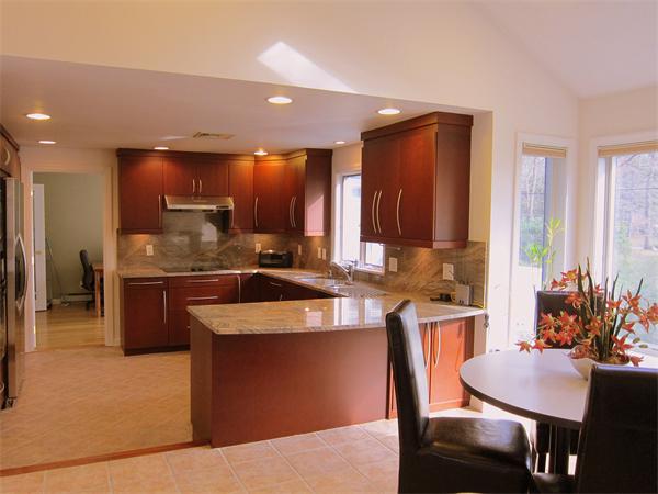 10 Elena Road Lexington, MA 02421 - Photo 3 of 19 a kitchen with stainless steel appliances granite countertop wooden cabinets a dining table and chairs