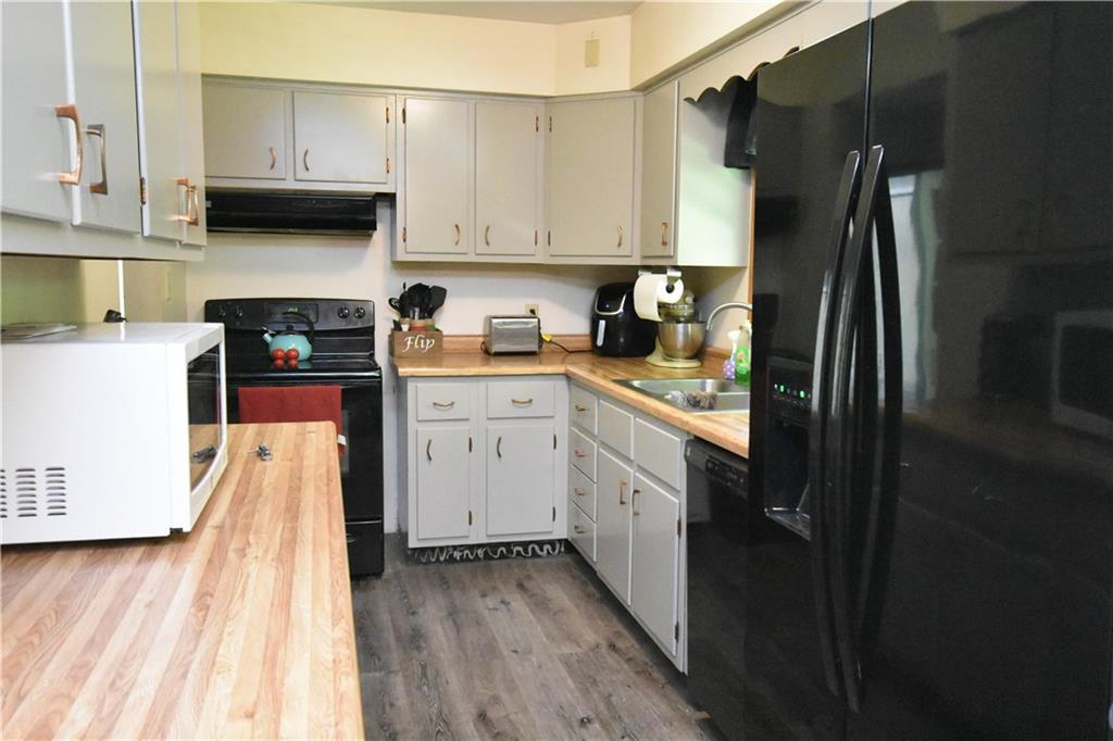 983 Mercer Grove City Road Mercer, PA 16137 - Photo 4 of 19 a kitchen with a sink a refrigerator and cabinets