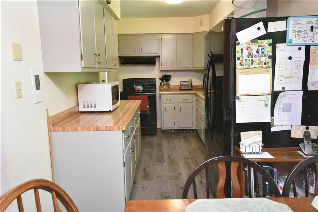 983 Mercer Grove City Road Mercer, PA 16137 - Photo 5 of 19 a kitchen with a refrigerator and a stove top oven