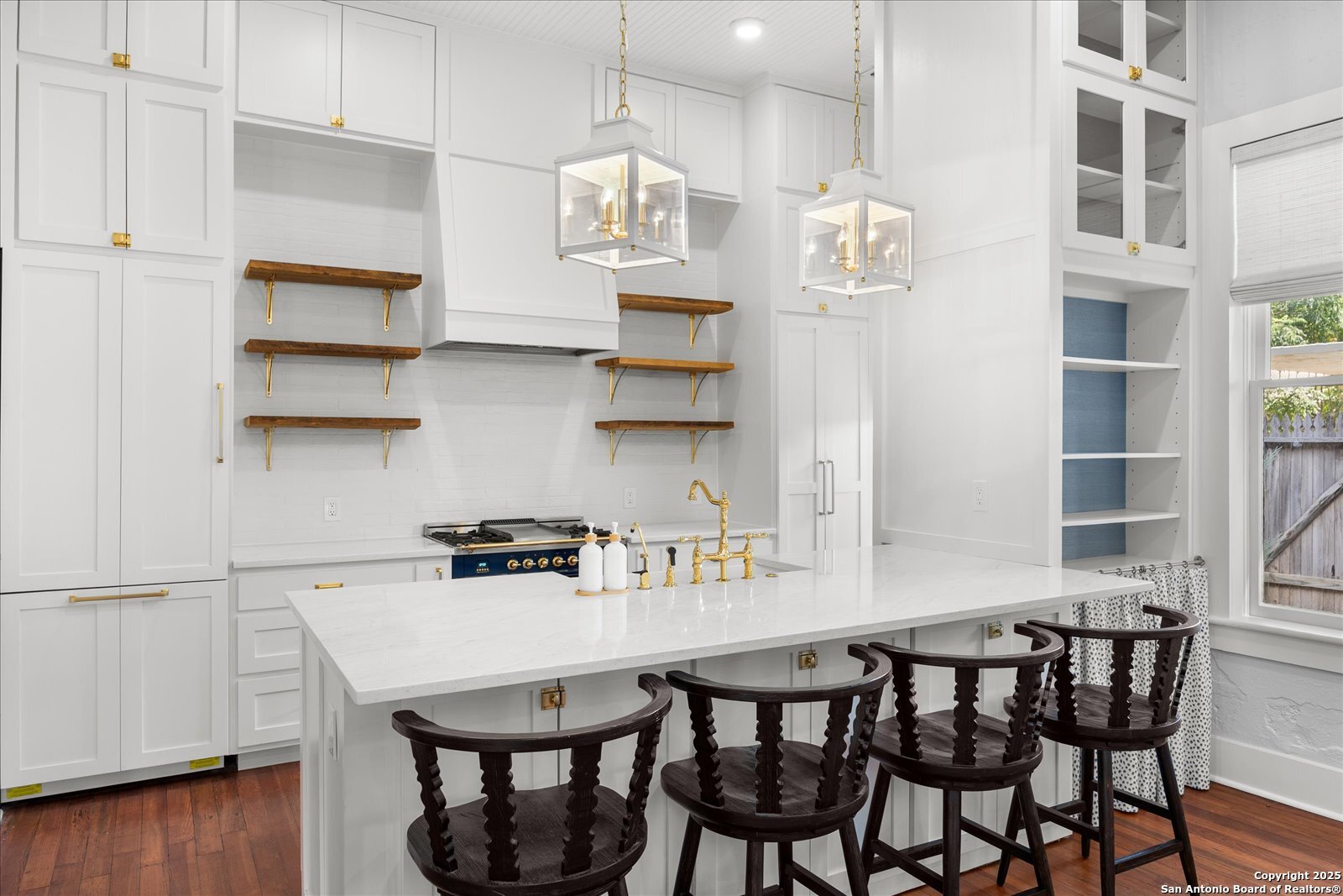 504 6th Street Comfort, TX 78013 - Photo 12 of 48 a kitchen with stainless steel appliances granite countertop a dining table chairs and view of living room