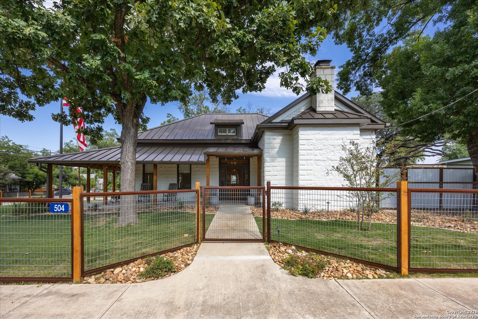504 6th Street Comfort, TX 78013 - Photo 2 of 48 a front view of a house with garden