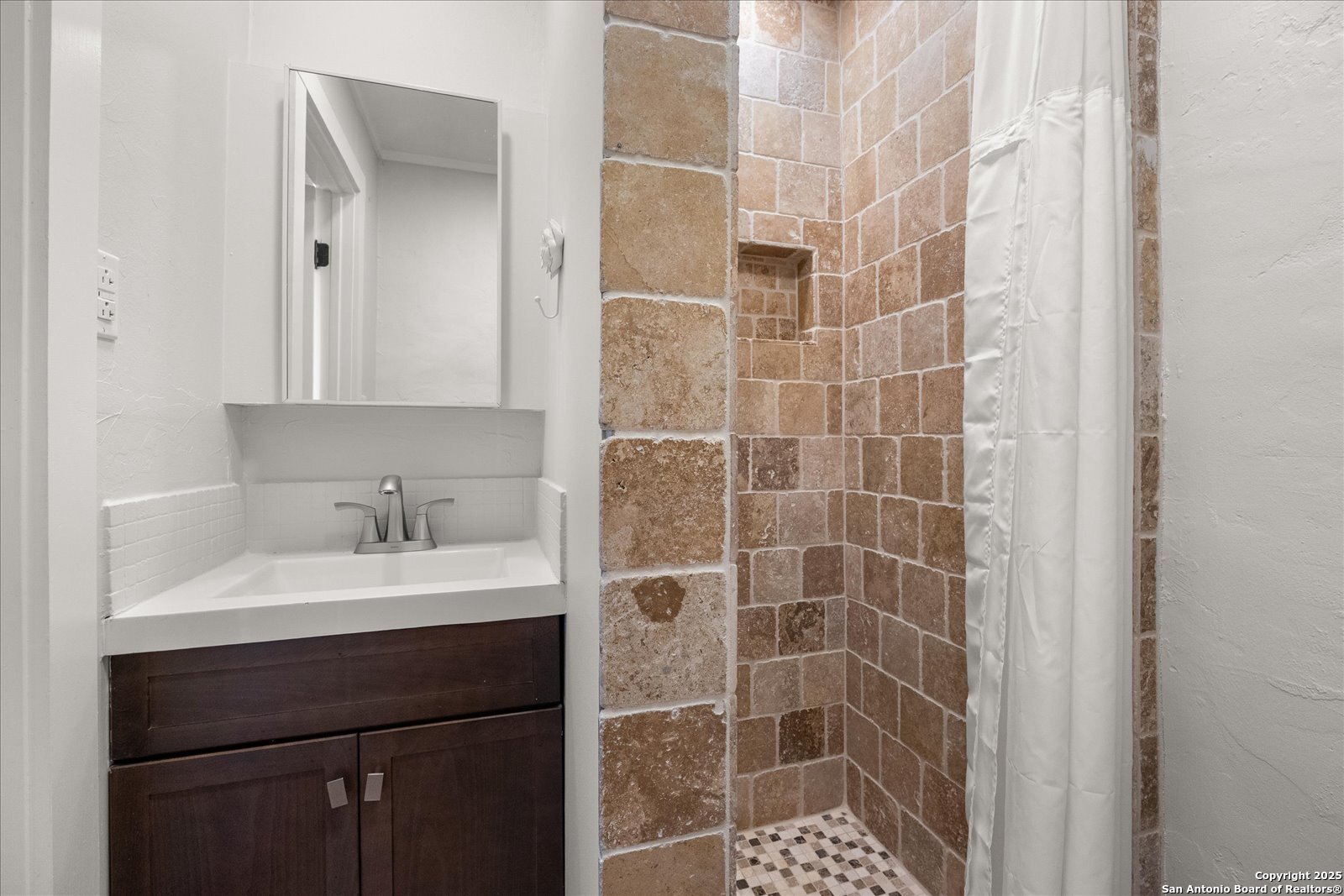 504 6th Street Comfort, TX 78013 - Photo 28 of 48 a bathroom with a shower a sink and a mirror