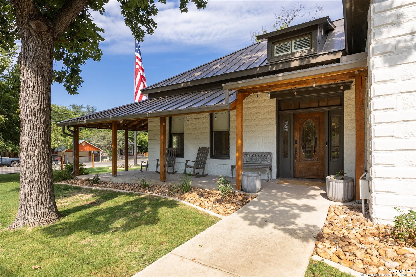 504 6th Street Comfort, TX 78013 - Photo 4 of 48 a view of a house with backyard sitting area and porch