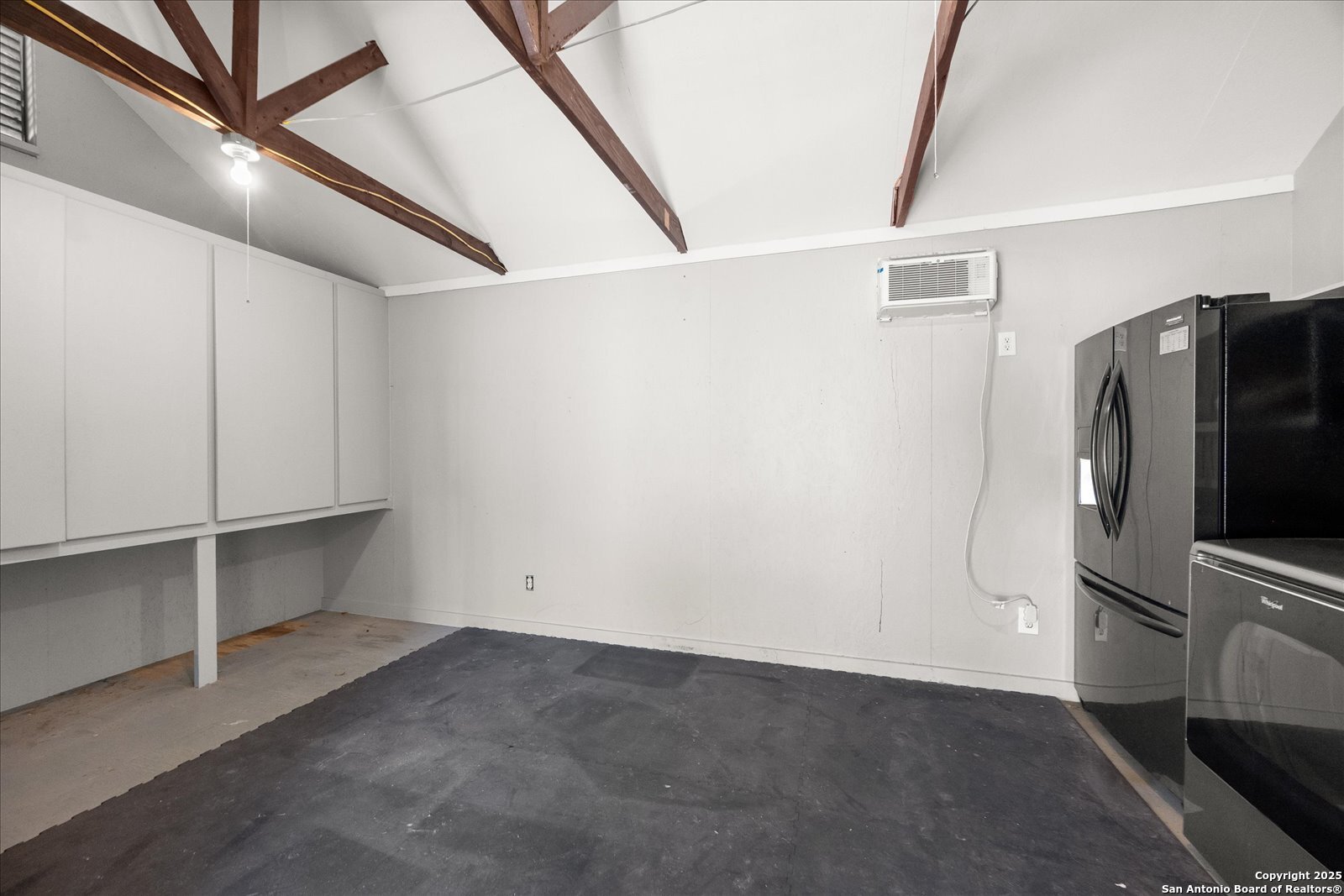 504 6th Street Comfort, TX 78013 - Photo 42 of 48 a view of a refrigerator in kitchen and an empty room