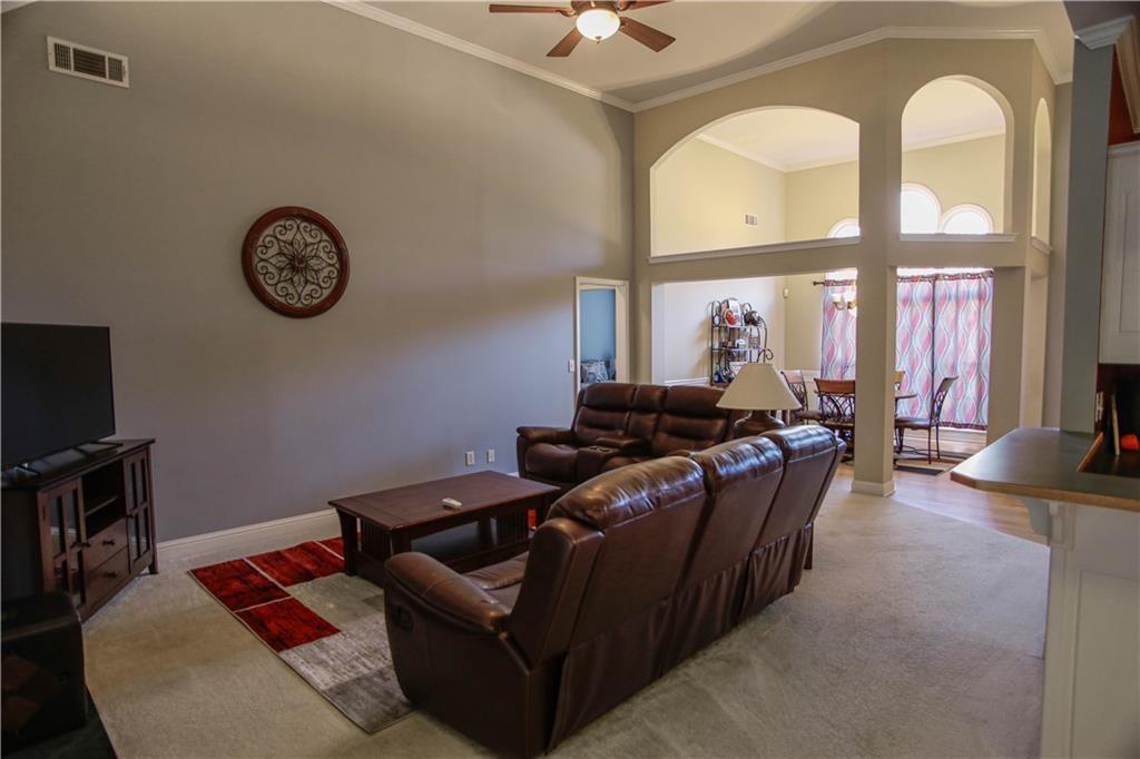 3875 Spring Manor Court Loganville, GA 30052 - Photo 7 of 23 a living room with furniture a rug and a flat screen tv