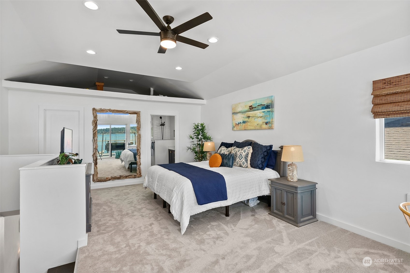 4234 Sunset Beach Road University Place, WA 98466 - Photo 23 of 40 a spacious bedroom with a bed and ceiling fan