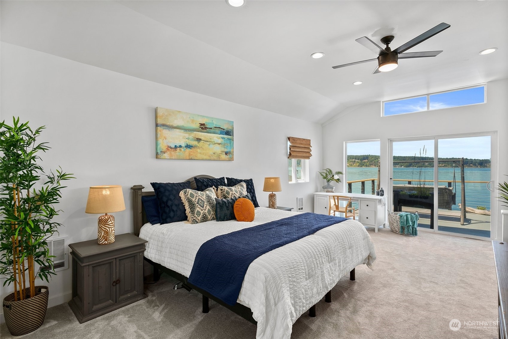 4234 Sunset Beach Road University Place, WA 98466 - Photo 24 of 40 a spacious bedroom with a bed a couch and a potted plant